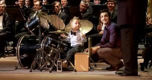 3-Year-Old Drummer Takes The Stage And Leads Orchestra Of Adult Musicians 3-Year-Old Drummer Takes The Stage And Leads Orchestra Of Adult Musicians
