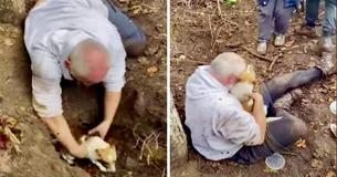 Een man begint te huilen nadat hij zijn vermiste hond uit een vossenhol heeft gered Een man begint te huilen nadat hij zijn vermiste hond uit een vossenhol heeft gered