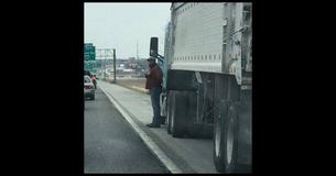 Woman Snaps A Photo Of A Truck Driver Standing On The Edge Of The Highway And Here's Why It Went Viral